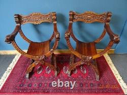A Lovely Pair of X Frame Green Man hand Carved Chairs in Savonarola Style