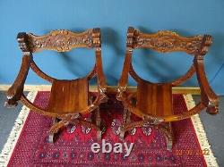 A Lovely Pair of X Frame Green Man hand Carved Chairs in Savonarola Style