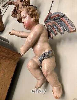 Paire de grandes figurines d'ange putti en bois antique sculptées et polychromes